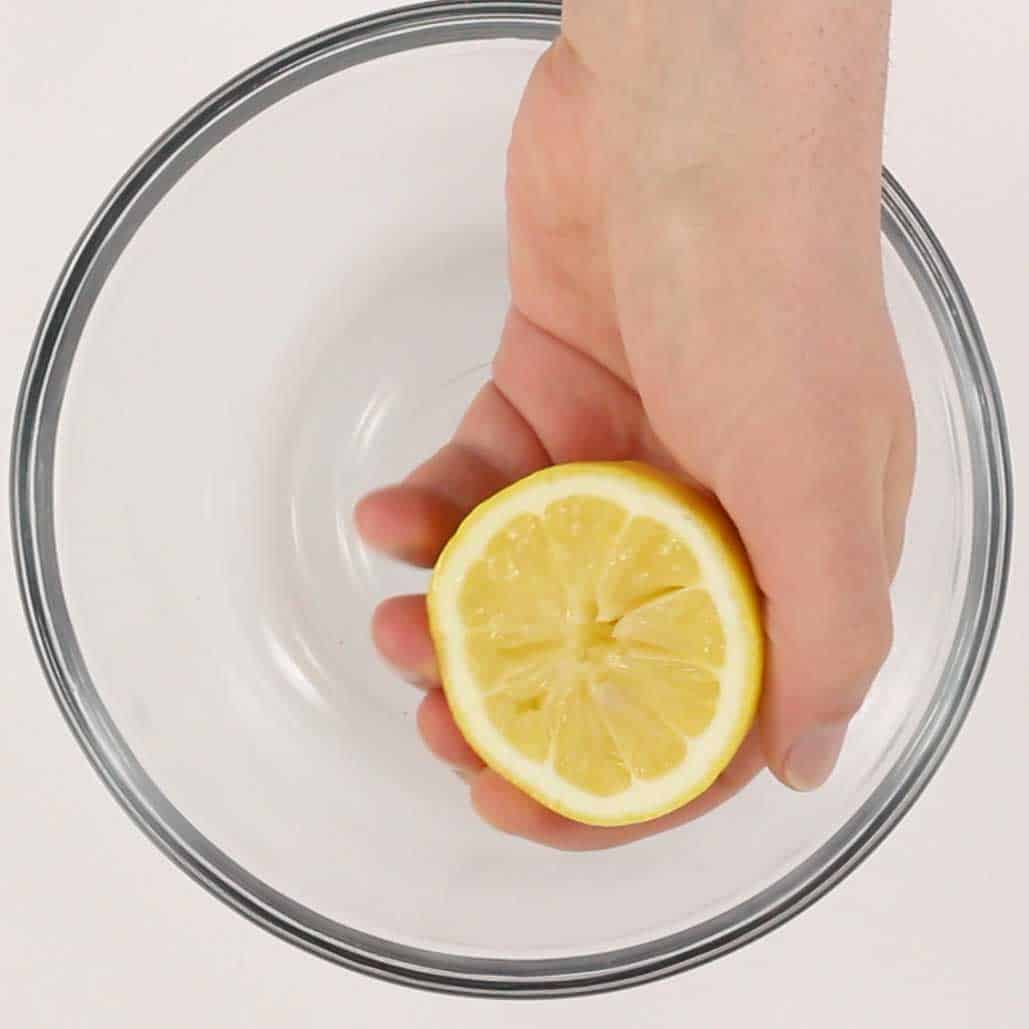 hand holding a lemon half